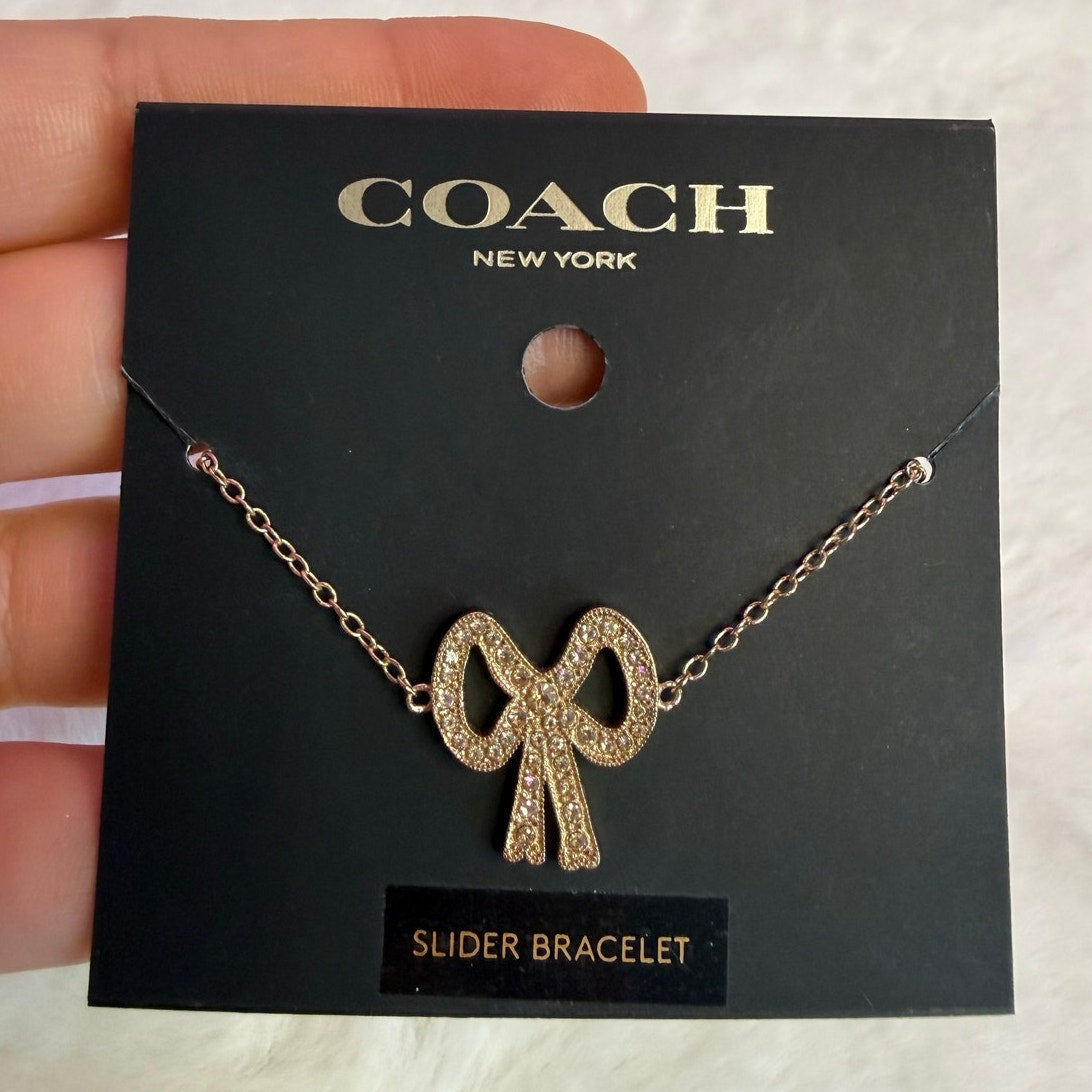 COACH Gold Tone Pave Bow Slider Bracelet