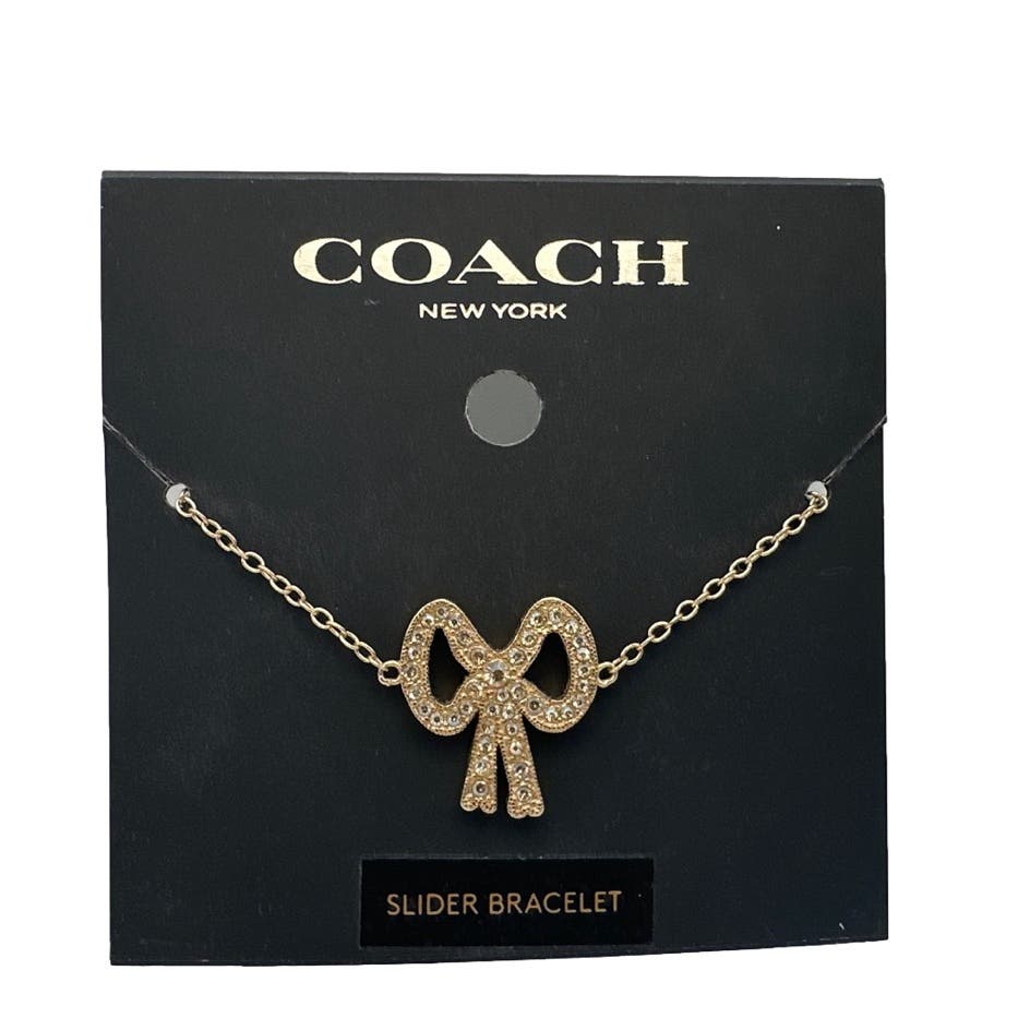 NWT Coach Pave Crystal Gold Tone Ribbon Charm Slider Bracelet