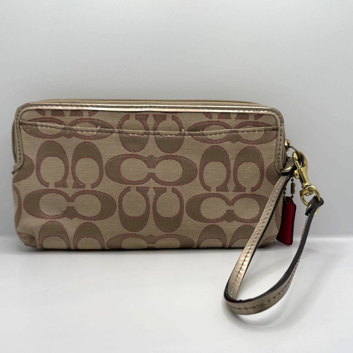 COACH Gold, Tan, and Pink Signature Canvas Wristlet